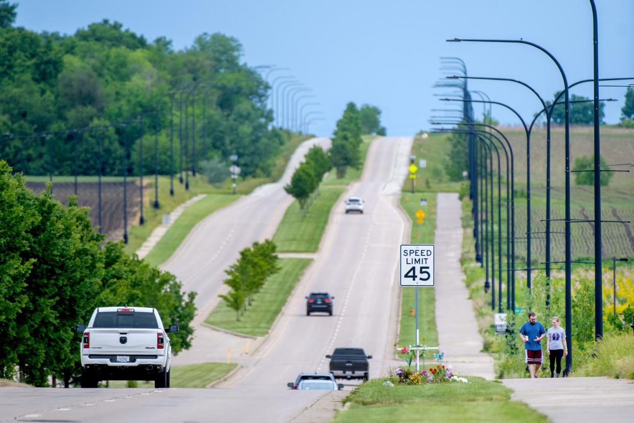 Vehicles and pedestrians pass by a memorial for Princeville teen Nevaeh Mitchell who died May 5, 2024, after a head-on collision May 4, 2024, in the 8400 block of Orange-Prairie Road in Peoria.