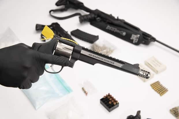 Police said they seized 31 firearms when they carried out 11 search warrants across Ontario on March 9, 2021.  (Ontario Provincial Police - image credit)