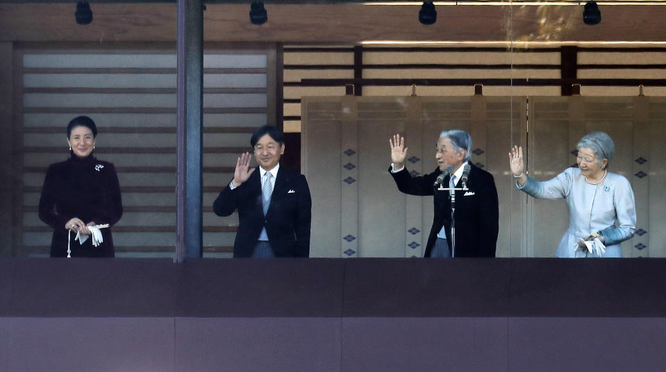 Japan's Emperor Akihito, second from right, waves with Empress Michiko, right, Crown Prince Naruhito and Crown Princess Masako to well-wishers from the balcony during his New Year's public appearance with his family members at Imperial Palace in Tokyo Wednesday, Jan. 2, 2019. Akihito waved Wednesday to throngs of well-wishers eager to see the final New Year’s appearance in his reign. (AP Photo/Eugene Hoshiko)