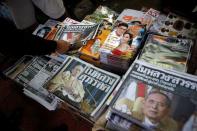 Newspapers carry the headlines of the passing of Thailand's King Bhumibol Adulyadej in Bangkok, Thailand October 14, 2016. REUTERS/Edgar Su