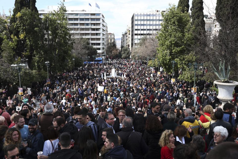 People gather during a protest at Syntagma square, in Athens, Greece, Sunday, March 5, 2023. Thousands protesters, take part in rallies around the country for fifth day, protesting the conditions that led the deaths of dozens of people late Tuesday, in Greece's worst recorded rail accident. The banner reads "It wasn't human error." (AP Photo/Yorgos Karahalis)