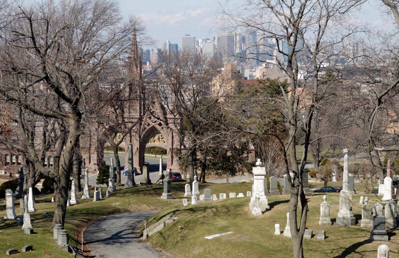 The Manhattan skyline is visible beyond Green-Wood Cemetery in Brooklyn, New York. 