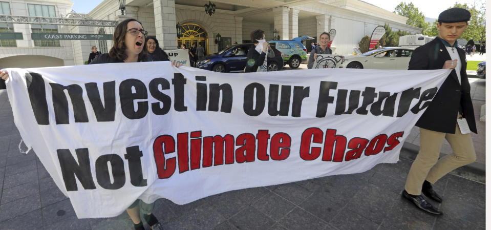 About 25 protesters leave after interrupting a energy conference where U.S. Energy Secretary Rick Perry spoke Thursday, May 30, 2019, in Salt Lake City. Perry says the Trump administration is committed to making fossil fuels cleaner rather than imposing "draconian" regulations on oil, gas and coal. Perry made his remarks during a speech at an energy conference in Salt Lake City hosted by Utah Gov. Gary Herbert. (AP Photo/Rick Bowmer)