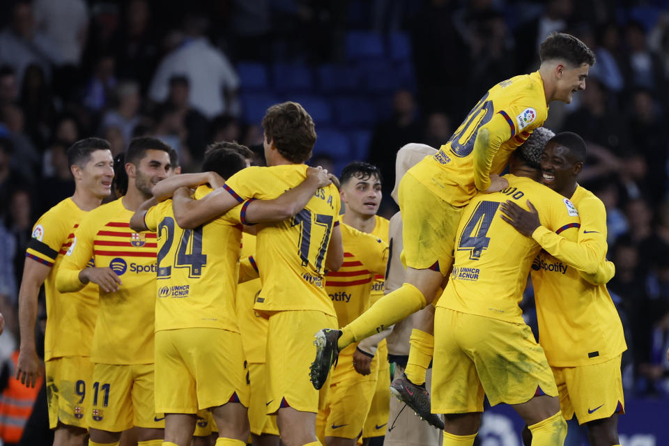 Barcelona players celebrate after the Spanish La Liga soccer match between Espanyol and Barcelona at the RCDE stadium in Barcelona, Sunday, May 14, 2023. (AP Photo/Joan Monfort)