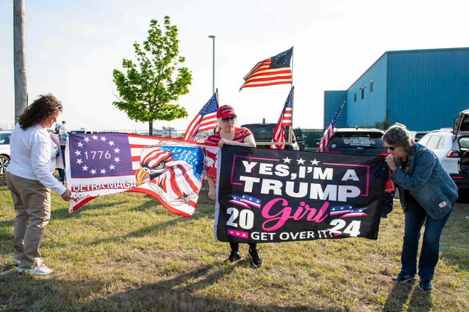 Supporters of former US President and 2024 Presidential hopeful Donald Trump rally to welcome him at Manchester airport in Manchester, New Hampshire, on May 10, 2023 ahead of his CNN town hall meeting.