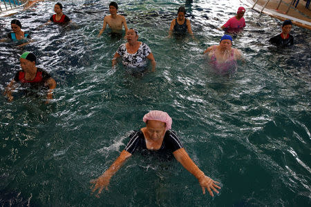 Elderly people attend an aquatic exercise at a private pool in Bangkok, Thailand, April 28, 2016. REUTERS/Athit Perawongmetha