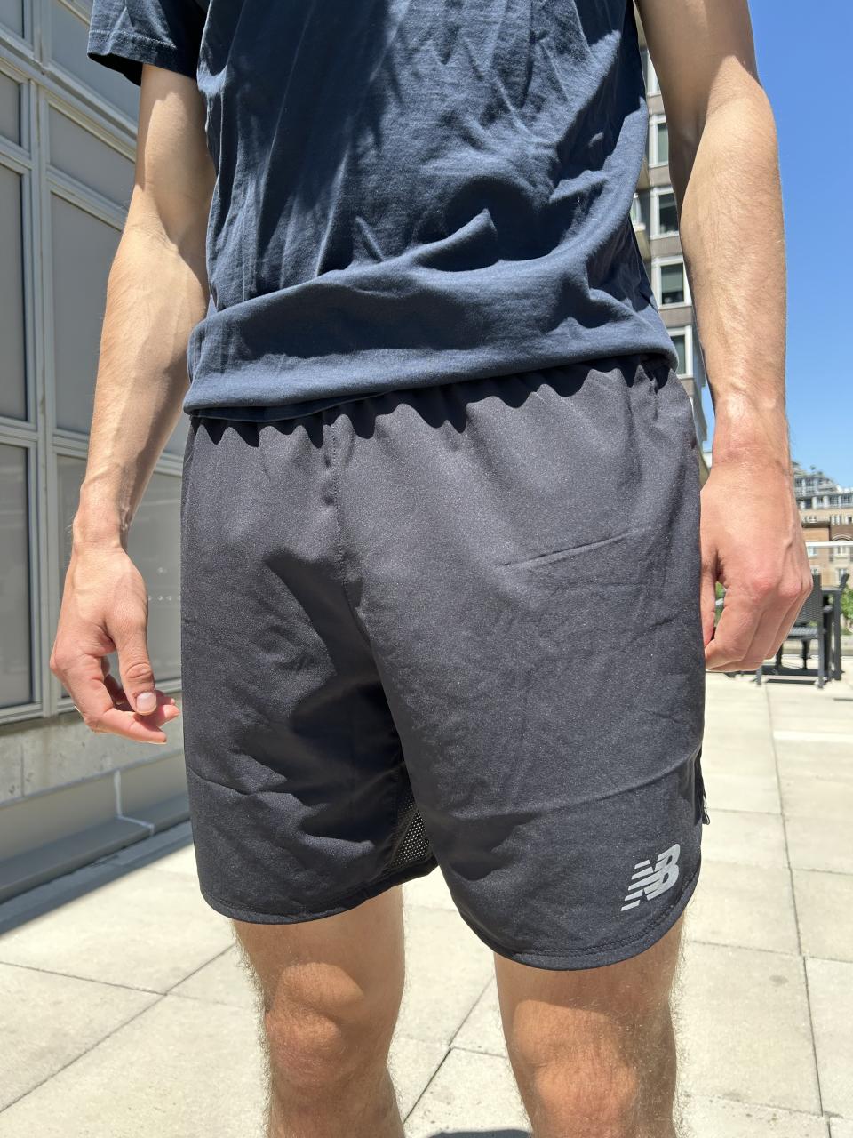 man wearing blue t-shirt and grey new balance shorts