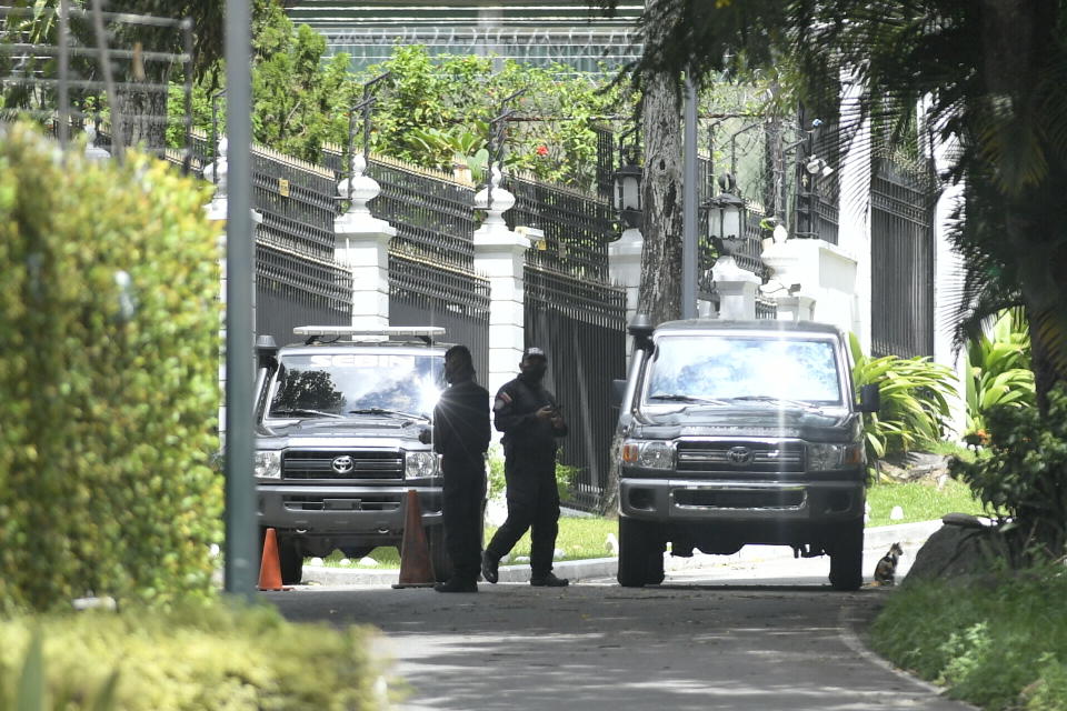 Members of the SEBIN intelligence police guard the perimeters of the Spanish ambassador's residence where opposition leader Leopoldo Lopez had been a guest after participating in a failed military uprising, in Caracas, Venezuela, Saturday, Oct. 24, 2020. Lopez left the residence where he had been sheltered since April 2019, and is leaving Venezuela people close to the opposition leader said Saturday. (AP Photo/Matias Delacroix)