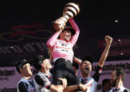 <p>Tom Dumoulin, of the Netherlands, holds up the trophy as he celebrates with teammates after winning the Giro d’Italia, Tour of Italy cycling race, in Milan, Sunday, May 28, 2017. (Photo: Antonio Calanni/AP) </p>