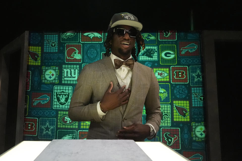 LSU wide receiver Brian Thomas Jr. reacts after putting on a hat after being chosen by the Jacksonville Jaguars with the 23rd overall pick during the first round of the NFL football draft, Thursday, April 25, 2024, in Detroit. (AP Photo/Jeff Roberson)