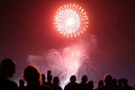 <p>People watch fireworks over the Del Mar fair in celebration of the 241st anniversary of the Declaration of Independence, in Del Mar, California, July 4, 2017. (Mike Blake/Reuters) </p>