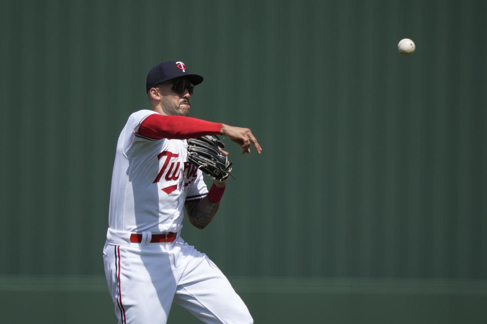 Minnesota Twins shortstop Carlos Correa (4) throws to first base on a groundout by Detroit Tigers Akil Baddoo in the first inning of a spring training baseball game in Fort Myers, Fla., Sunday, March 5, 2023. (AP Photo/Gerald Herbert)