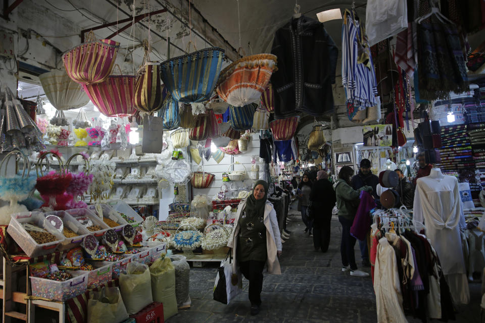 Tunisian shop at a popular market in the Old City of Tunis, Tunisia, Thursday, March 28, 2019. Tunisia is cleaning up its boulevards and securing its borders for an Arab League summit that this country hopes raises its regional profile and economic prospects. Government ministers from the 22 Arab League states are holding preparatory meetings in Tunis all week for Sunday's summit. (AP Photo/Hussein Malla)