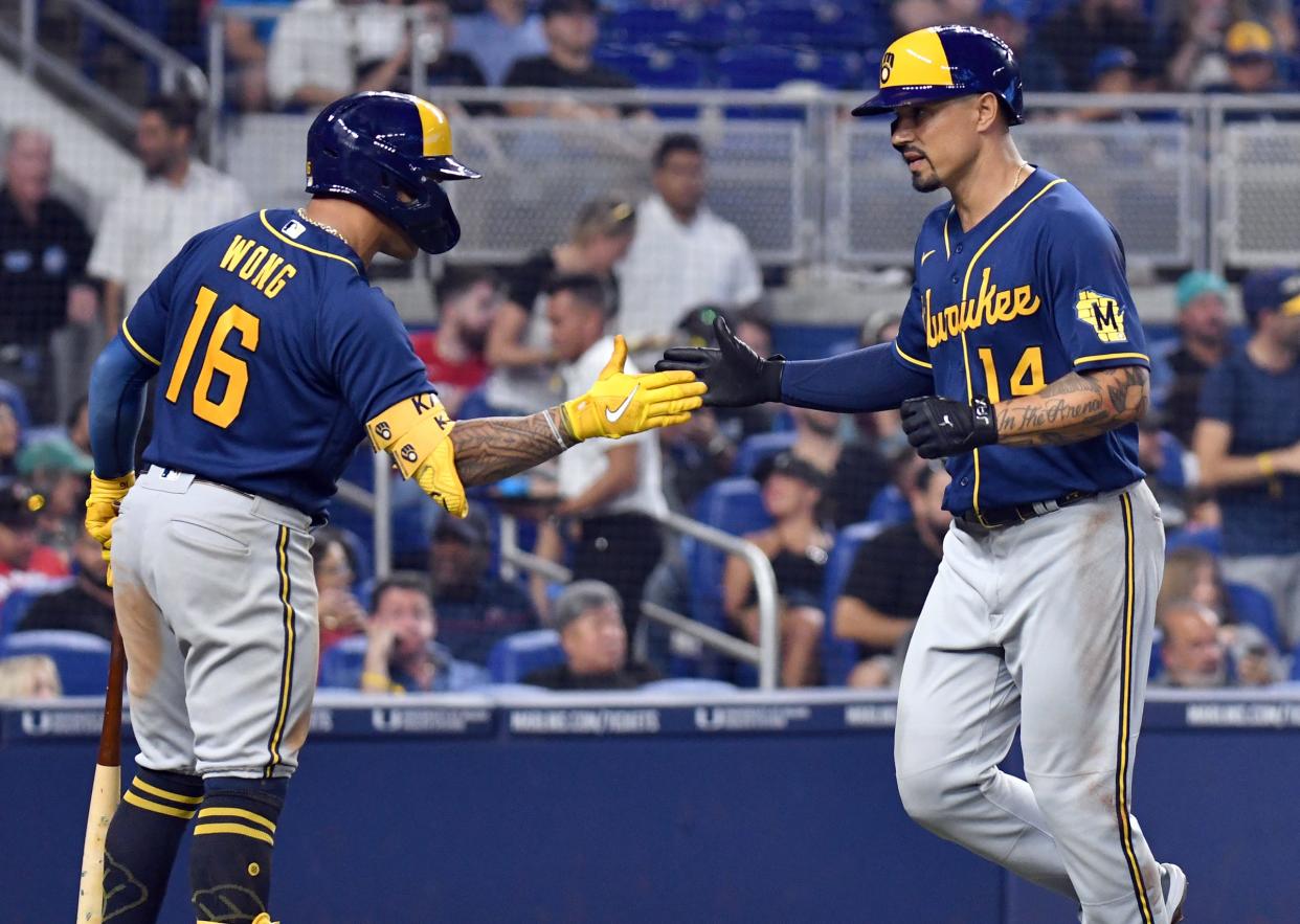 The Brewers' Jace Peterson is greeted at the plate by Kolten Wong after hitting a home run in the fifth inning Sunday.