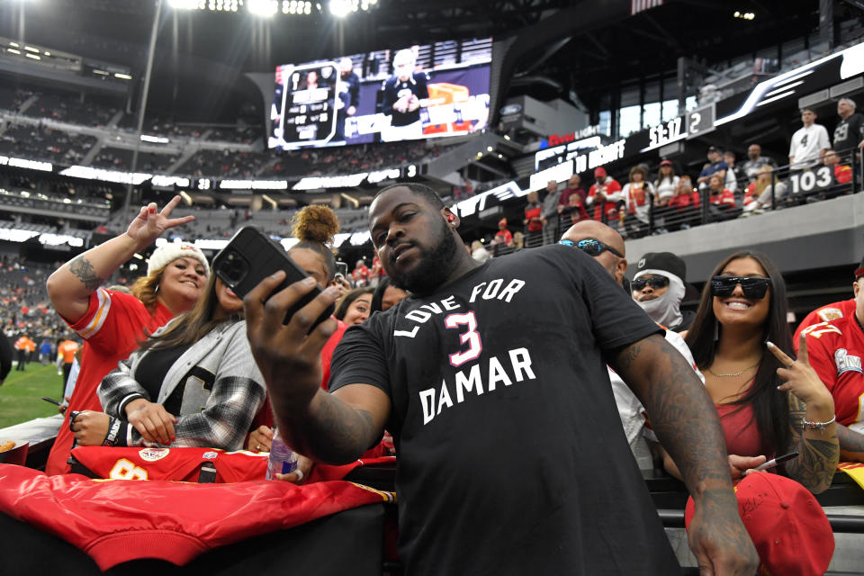 Kansas City Chiefs defensive tackle Khalen Saunders wears a T-shirt paying tribute to Buffalo Bills safety Damar Hamlin while taking photos with fans before the start of an NFL football game between the Las Vegas Raiders and Kansas City Chiefs Saturday, Jan. 7, 2023, in Las Vegas. (AP Photo/David Becker)