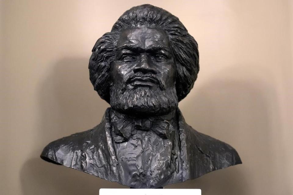 A bust of famed abolitionist Frederick Douglass, by artist Lloyd Lillie, rests in the Senate Chamber after is was unveiled during ceremonies, Wednesday, Feb. 14, 2024, at the Massachusetts Statehouse, in Boston. It's the first bust of an African American to be permanently added to the Mass. Statehouse, and the first bust to be added to the Senate Chamber in more than 125 years.