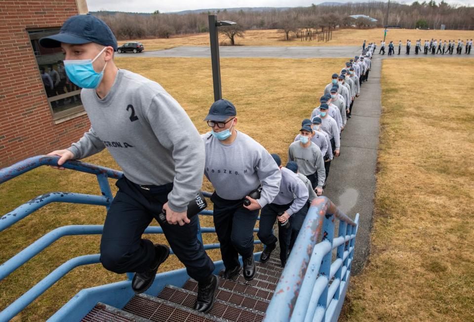 Members of the 88th Recruit Training Troop file into a building Tuesday at the Mass. State Police Academy in New Braintree.