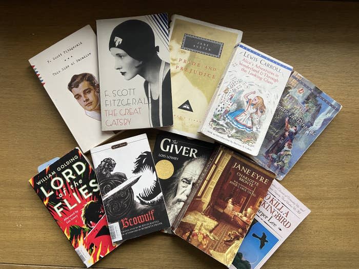 Photo of a spread of books including "To Kill a Mockingbird," "Jane Eyre," "The Giver," "Beowulf," "Lord of the Flies," "Cyrano," "Alice's Adventures in Wonderland," "Pride and Prejudice," "The Great Gatsby," and "This Side of Paradise"