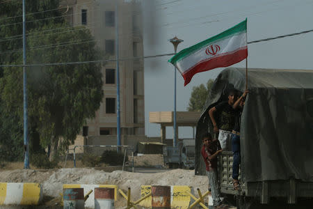 Iranian flag flutters on a truck carrying humanitarian aid in Deir al-Zor, Syria September 20, 2017. Picture taken September 20, 2017. REUTERS/Omar Sanadiki