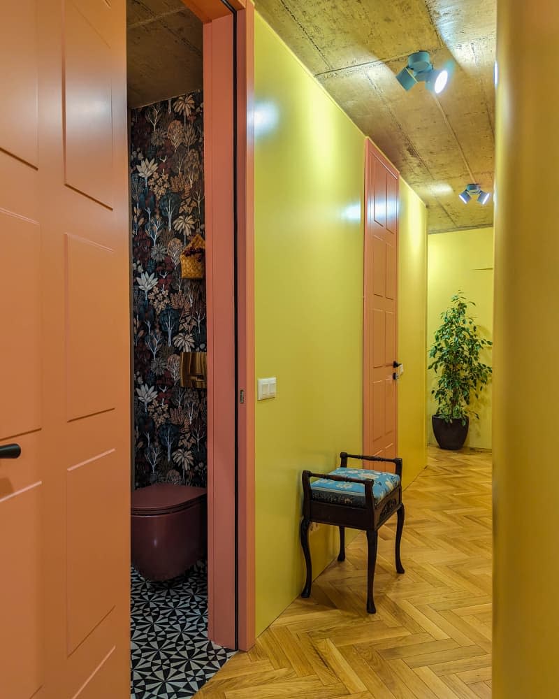 yellow and orange hallway with parquet wood floors