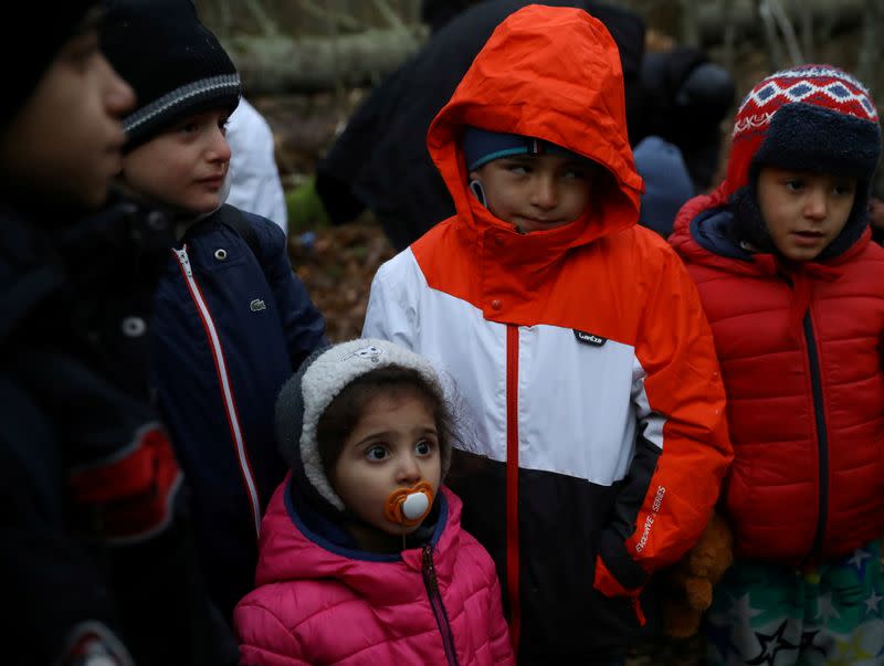 Migrants gather in a forest near the Polish-Belarusian border outside Narewka