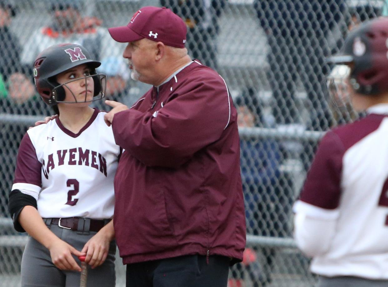 Mishawaka Head Coach Brian Miller talks to Lilly St. Clair during the Northridge vs. Mishawaka girls softball game Friday, April 28, 2023, at Ward Baker Park in Mishawaka.