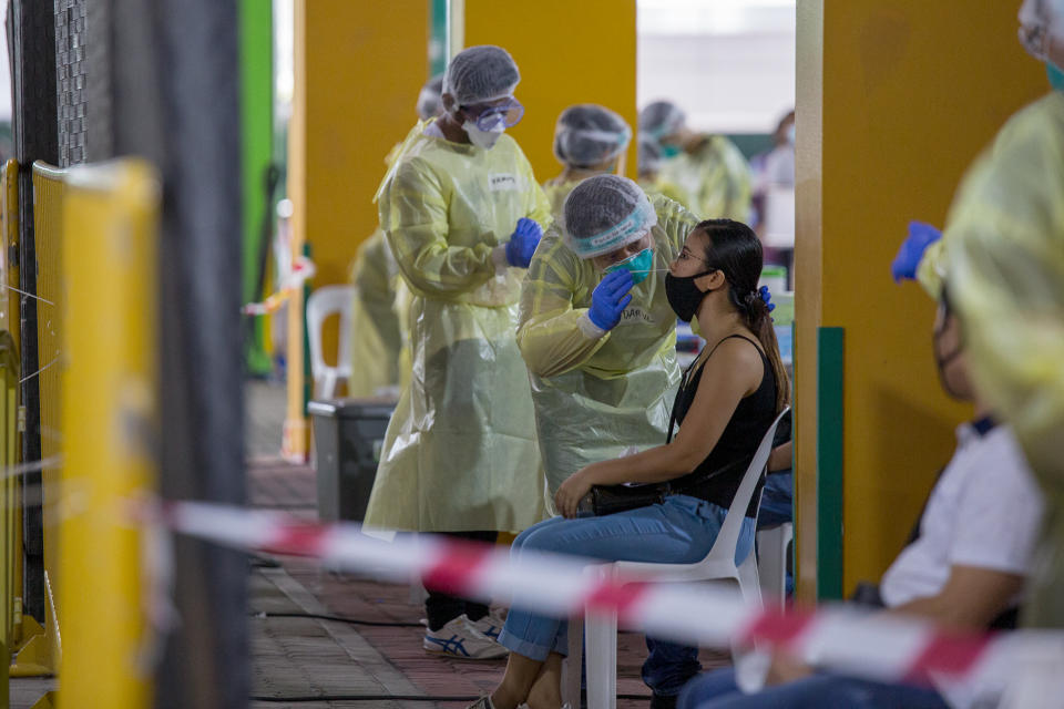 A woman receives a nasal swab at the regional COVID-19 screening centre at The Float @ Marina Bay on 12 June 2020. (PHOTO: Dhany Osman / Yahoo News Singapore)