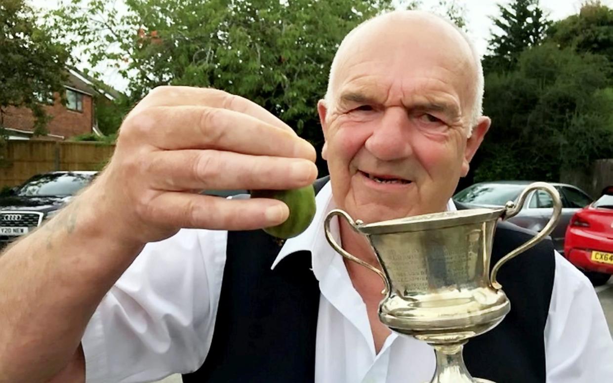 Terry Price and his champion gooseberry in 2020 - John Williams/SWNS