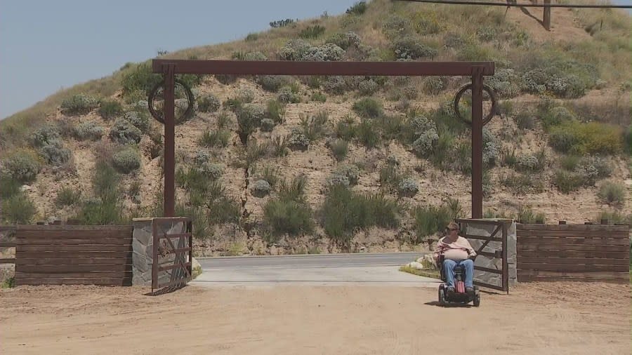 Fernando Ibarra near the entrance to his Reche County ranch in Riverside County. (KTLA)