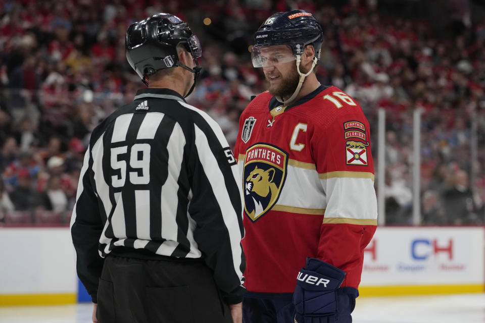 Florida Panthers center Aleksander Barkov (16) talks to linesman Steve Barton (59) during the second period of Game 3 of the NHL hockey Stanley Cup Finals against the Vegas Golden Knights, Thursday, June 8, 2023, in Sunrise, Fla. (AP Photo/Lynne Sladky)