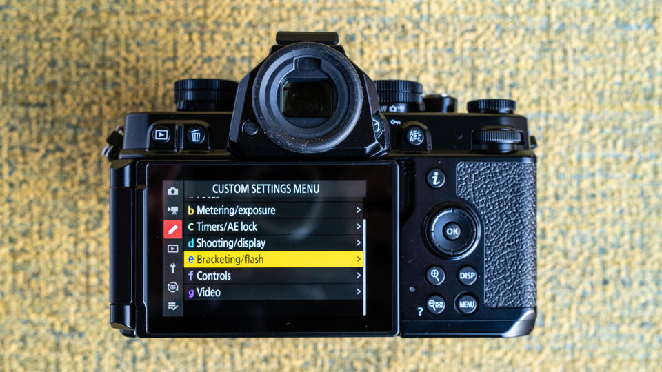 Nikon Z f camera on a vintage-style yellow chair