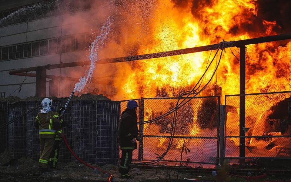 Firefighters work to put out a fire in a thermal power plant, damaged by a Russian missile strike in Kyiv -  Shutterstock