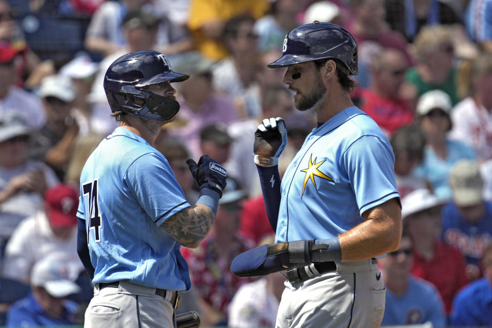 Tampa Bay Rays' Josh Lowe, right, celebrates with Ben Gamel after Lowe scored on an RBI single by Manuel Margot off Philadelphia Phillies starting pitcher Bailey Falter during the first inning of a spring training baseball game Tuesday, March 7, 2023, in Clearwater, Fla. (AP Photo/Chris O'Meara)