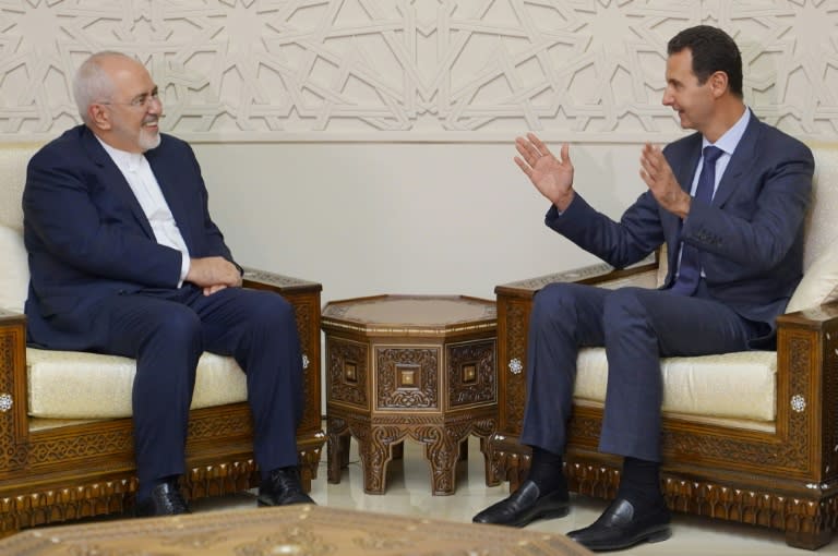 Iranian Foreign Minister Mohammad Javed Zarif's (L) meets with Syrian President Bashar al-Assad