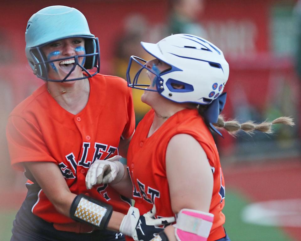 Ellet base runner Emily Kearns, left, celebrates their victory over Firestone with teammate Grace Norman at their game at Firestone Stadium on Monday, April 29, 2024 in Akron.
