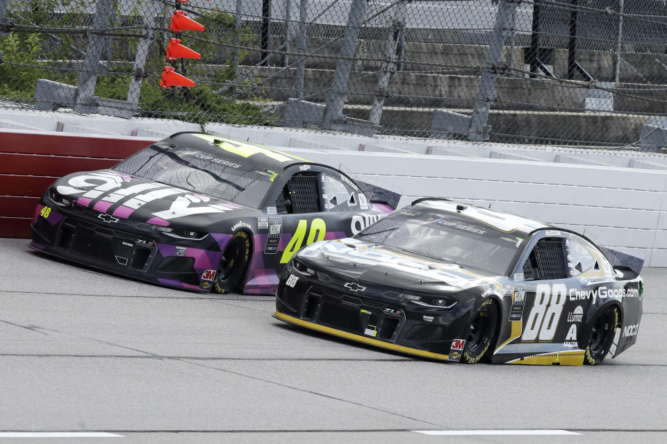 FILE - In this Sunday, May 17, 2020, file photo, Jimmie Johnson (48) and Alex Bowman (88) come down a straightaway during a NASCAR Cup Series auto race in Darlington, S.C. The most coveted seat in NASCAR went to Alex Bowman in a Hendrick Motorsports lineup shuffle to replace seven-time champion Jimmie Johnson in the iconic No. 48 Chevrolet. Bowman and crew chief Greg Ives will move from the No. 88 into Johnson's ride at the end of the season. The swap announced Tuesday, Oct. 6, 2020, makes Bowman just the second driver of the team created in 2001 specifically for Johnson.(AP Photo/Brynn Anderson, File