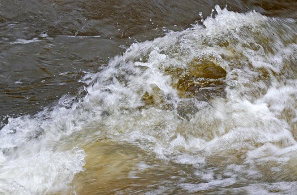 The waters of the Cuyahoga River rush through Cascade Valley Metro Park in Akron on , Monday.