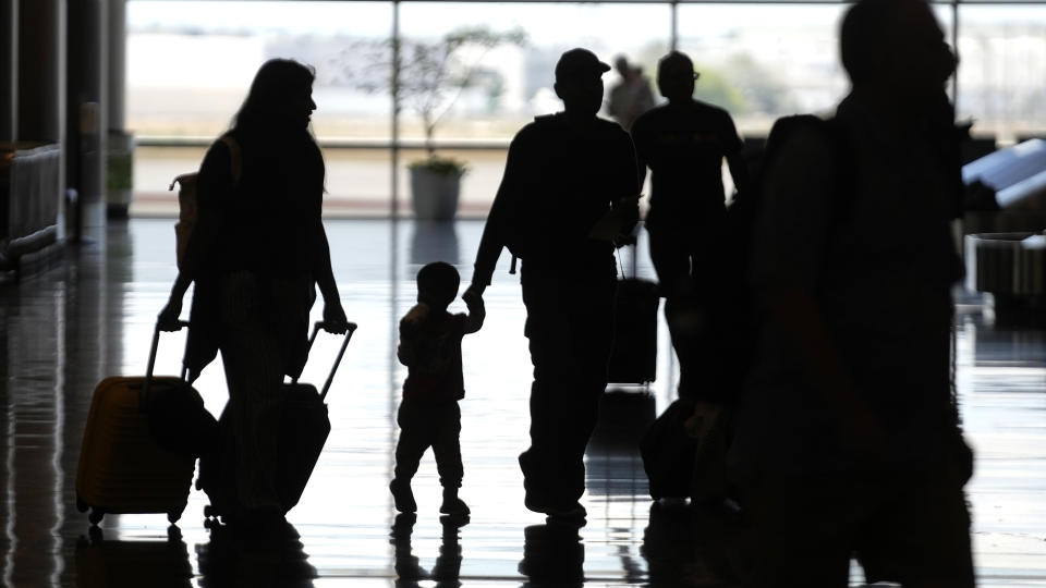 People travel through Salt Lake City International Airport Friday, June 30, 2023, in Salt Lake City. (AP Photo/Rick Bowmer)