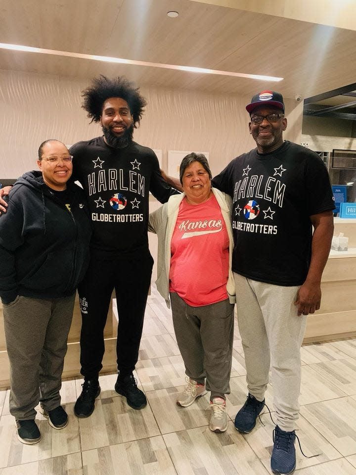 Topeka City Councilwoman Sylvia Ortiz, second from right, and her daughter, Tania Gibbs, far left, posed Sunday with two men from the Harlem Globetrotters.