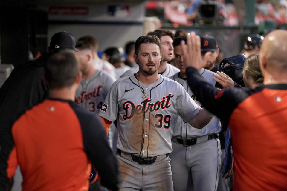 Detroit Tigers' Zach McKinstry (39) is congratulated in the dugout after scoring against the Los Angeles Angels during the fourth inning of a baseball game in Anaheim, Calif., Saturday, June 29, 2024. (AP Photo/Eric Thayer)