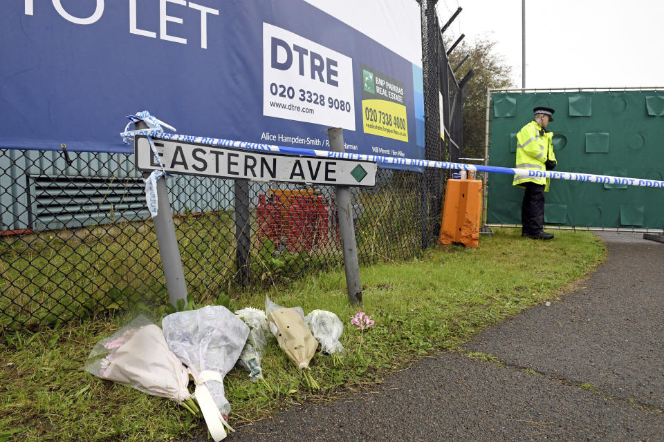 Floral tributes at the Waterglade Industrial Park in Thurrock, Essex, England Thursday Oct. 24, 2019 the day after 39 bodies were found inside a truck on the industrial estate. British media are reporting that the 39 people found dead in the back of a truck in southeastern England were Chinese citizens. (Stefan Rousseau, PA via AP)