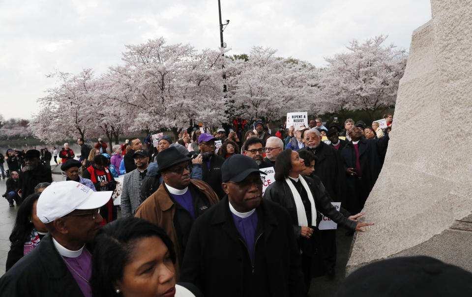 <p>Anti-racism marchers from the National Council of the Churches of Christ in the USA and ACT (Awaken, Confront, Transform) to End Racism reach out to touch the Rev. Martin Luther King Jr. Memorial as they engage in a silent march and rally to mark the 50th anniversary of the slain civil rights leader’s assassination in Washington, April 4, 2018. (Photo: Leah Millis/Reuters) </p>