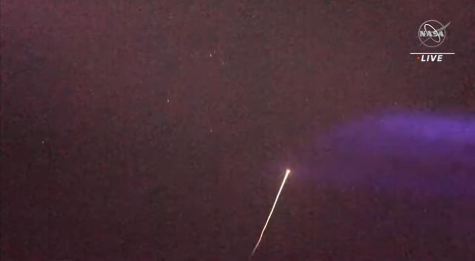 SpaceX Crew-5 Dragon Endurance streaks across the night sky over the ocean off the coast of Tampa Bay, Florida during splashdown and landing activities on March 11, 2023.