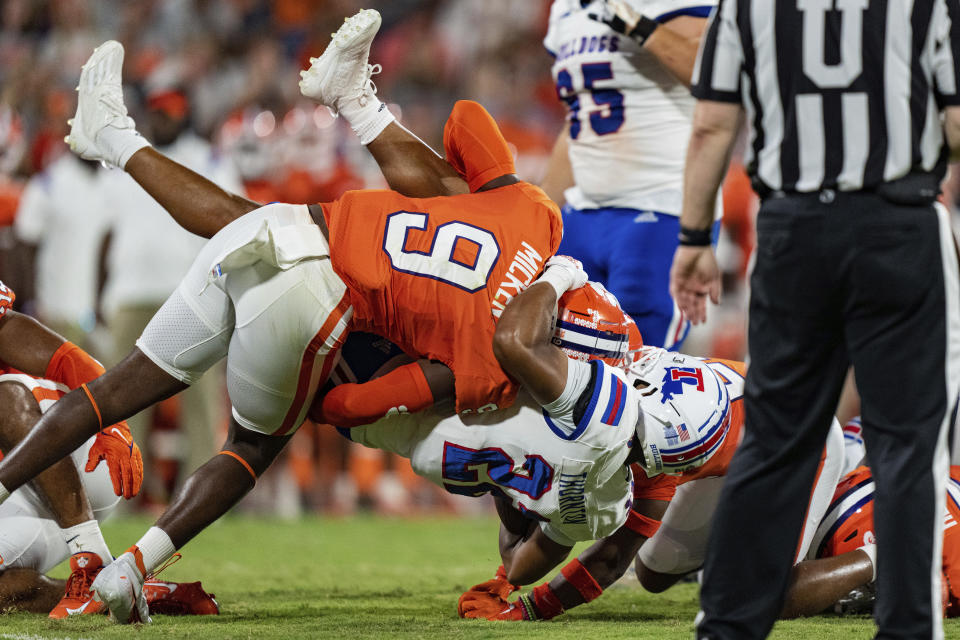 Clemson safety R.J. Mickens (9) tackles Louisiana Tech running back Charvis Thornton (22) during the first half of an NCAA college football game Saturday, Sept. 17, 2022, in Clemson, S.C. (AP Photo/Jacob Kupferman)