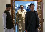 Pakistan's Prime Minister Imran Khan arrives to an interview with The Associated Press, in Islamabad, Pakistan, Monday, March 16, 2020. Khan said Monday he fears the new coronavirus will devastate developing nations' economies, and warned richer economies to prepare to write off the debts of the world's poorer countries. In the interview he also called for an end to sanctions on Iran saying they were crippling the poor nation's ability to even contain the spread of the coronavirus. For most people, the virus causes only mild or moderate symptoms. For some it can cause more severe illness. (AP Photo/B.K. Bangash)