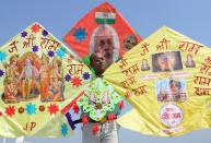 A kite-maker poses with kites decorated with the pictures of Ram Temple, lord Ram Darbar and India's Prime Minister Narendra Modi, in Amritsar on August 4, 2020, a day before the ground-breaking ceremony for the construction of Lord Ram Temple in Ayodhya. - India's Prime Minister Narendra Modi will lay the foundation stone for a grand Hindu temple in a highly anticipated ceremony at a holy site that was bitterly contested by Muslims, officials said. The Supreme Court ruled in November 2019 that a temple could be built in Ayodhya, where Hindu zealots demolished a 460-year-old mosque in 1992. (Photo by Narinder NANU / AFP) (Photo by NARINDER NANU/AFP via Getty Images)