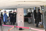 People wait for the coronavirus testing at a makeshift testing site in Seoul, South Korea, Wednesday, Nov. 24, 2021. New coronavirus infections in South Korea exceeded 4,000 in a day for the first time since the start of the pandemic as a delta-driven spread continues to rattle the country after it eased social distancing in recent weeks to improve its economy. (AP Photo/Ahn Young-joon).