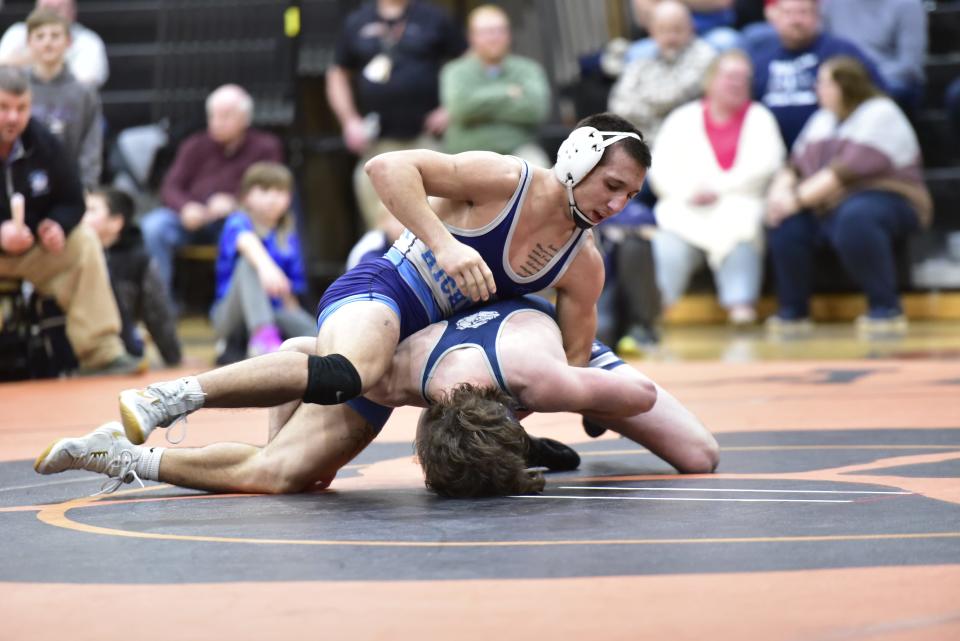 Richmond's Joey Polio (above) wrestles Yale's Alex McMillin during the Blue Devils' 44-26 win in a Division 3 district final at Armada High School on Thursday.