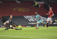 Liverpool's Mohamed Salah, center, scores his side's fourth goal during the English Premier League soccer match between Manchester United and Liverpool, at the Old Trafford stadium in Manchester, England, Thursday, May 13, 2021. (Peter Powell/Pool via AP)