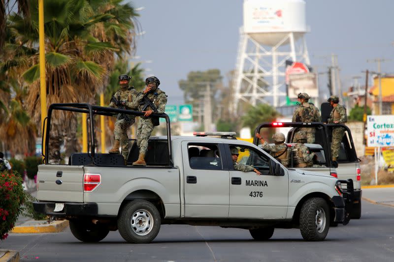 Mexico's Navy personnel patrol an area after a shooting with unknown assailants, in Cortazar